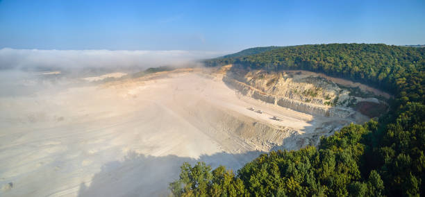 istock Aerial view of open pit mining of limestone materials for construction industry with excavators and dump trucks. 2160338311