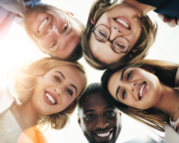 istock Below, face and employees with smile on portrait for teamwork, collaboration and unity. Business, people and happy with confidence in circle for support, solidarity and pride for diversity in office 2160338690