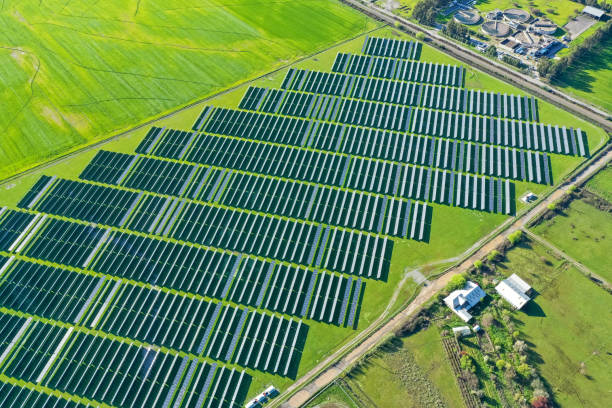 istock Solar panels on field in summer, aerial drone view 2160338939