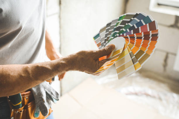 istock worker doing renovations in an apartment, Color Swatch, 2160338970
