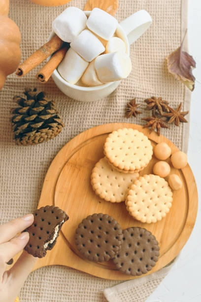 istock Assorted Biscuits with Marshmallows on Wooden Board offer a cozy autumn snack with warm flavors 2160339335