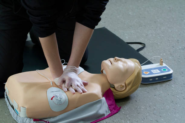 istock First responce worker demonstrades CPR and proper defibrillator procedure on a manikin. 2160345026