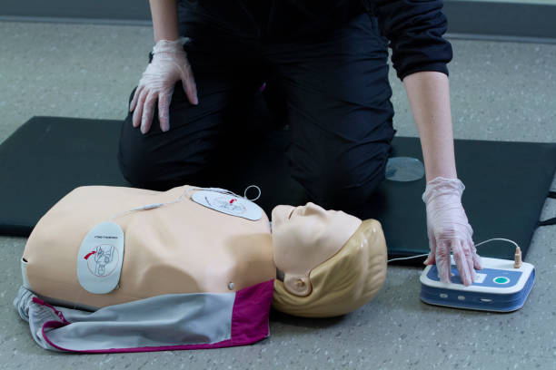istock First responce worker demonstrades CPR and proper defibrillator procedure on a manikin. 2160345028