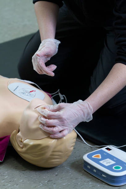 istock First responce worker demonstrades CPR and proper defibrillator procedure on a manikin. 2160345029