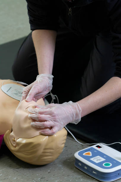 istock First responce worker demonstrades CPR and proper defibrillator procedure on a manikin. 2160345032