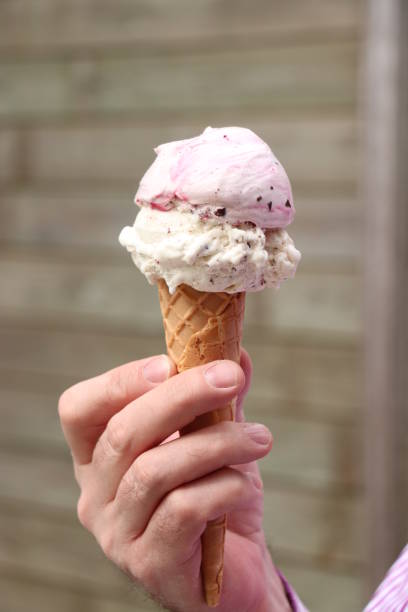 istock Man holding ice cream cone 2160346075