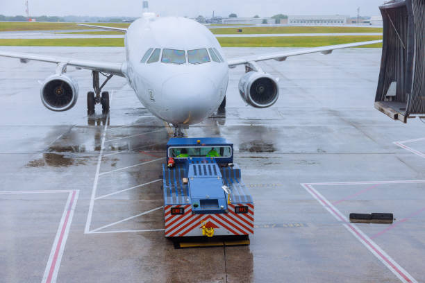 istock During rain, preparation for departure airplane is rolled out from terminal gate ready for a takeoff 2160348261