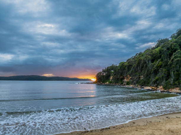 istock Sunrise seascape with rain clouds and flat surf 2160354188