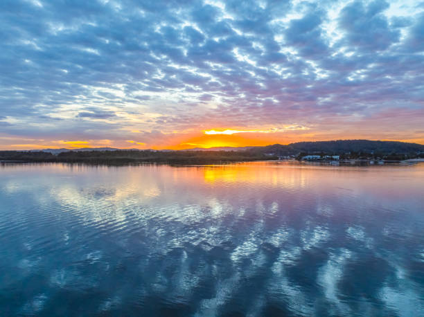 istock Sunrise over the bay water with clouds and reflections 2160354203