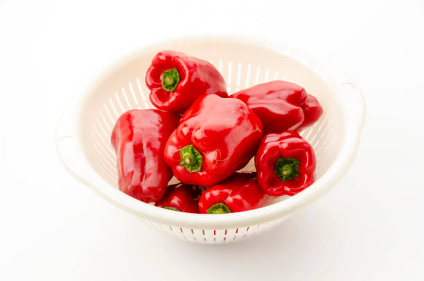 fresh red peppers just harvested and dried pumpkins on old wood