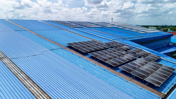 istock top view of grid of technology renewable solar energy. construction solar panels system on roof. Installing solar photovoltaic panel system. background of blue of solar cell system and structure roof. 2160358615