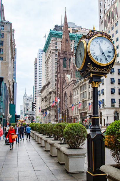 The Trump Tower Street clock and the facade of the Presbyterian church in Fifth Avenue, Manhattan, New York City