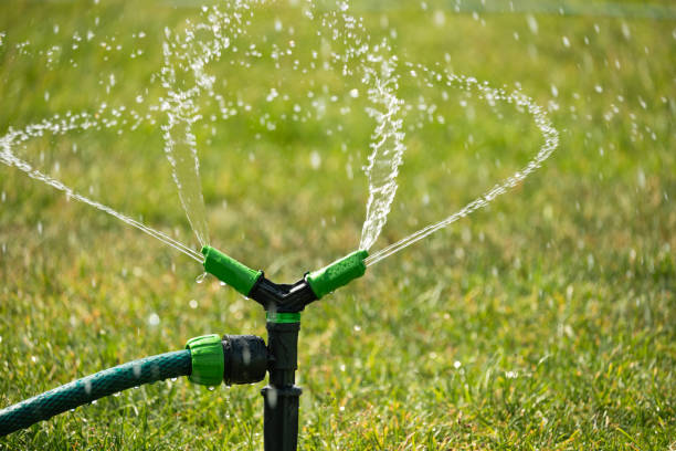 istock Green lawn automatic irrigation system in park. Watering lawn at heat summer. 2160360104