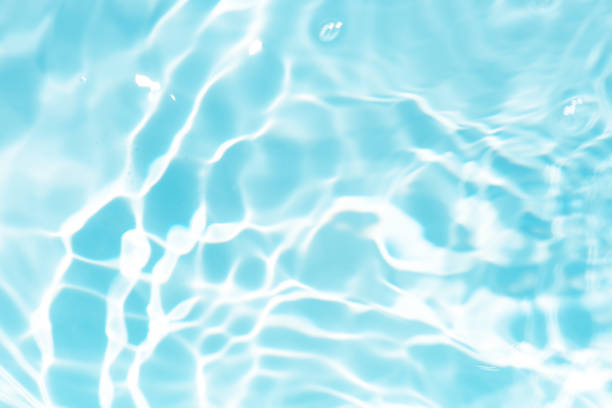 istock Blue water with ripples on the surface. Defocus blurred transparent blue colored clear calm water surface texture with splashes and bubbles. Water waves with shining pattern texture background. 2160360198