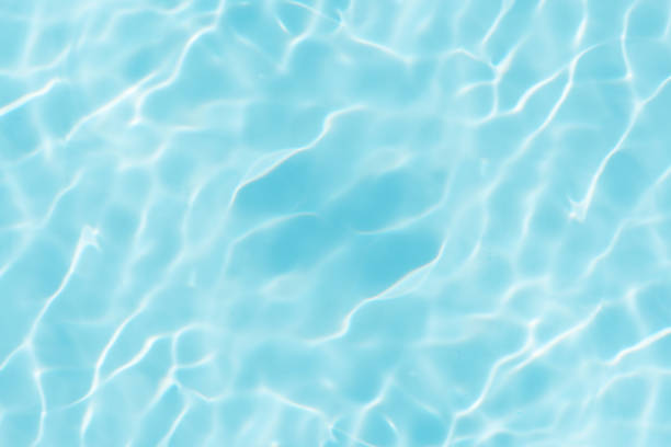 istock Blue water with ripples on the surface. Defocus blurred transparent blue colored clear calm water surface texture with splashes and bubbles. Water waves with shining pattern texture background. 2160360208