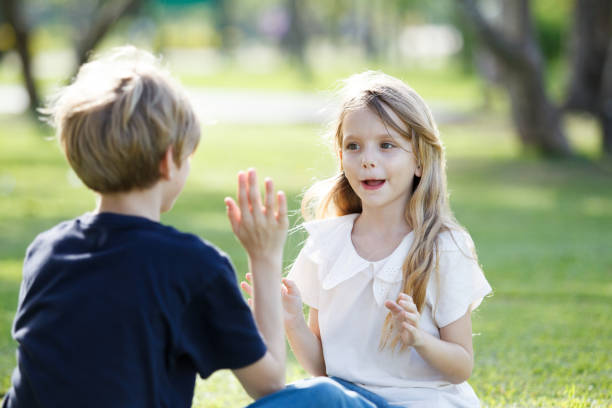 istock White children running together at the park. 2160363026