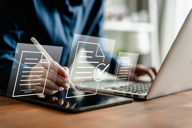 istock Businesswomen using a stylus pen to sign one document on a virtual notebook screen, E-signing, electronic signature, document management, and paperless office concept. 2160368226