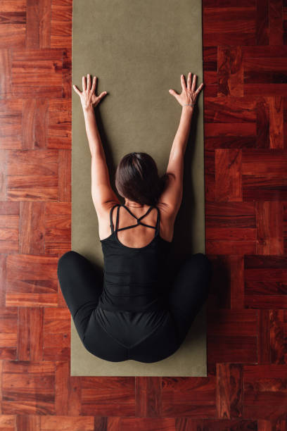 istock Latin woman bending forward practicing yoga. Copy space. 2160369067