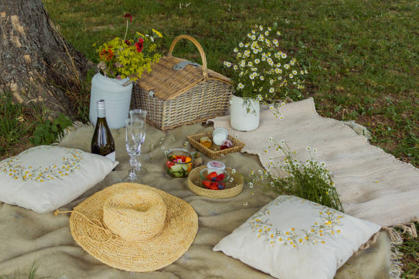 istock Beautiful white boho style decor. Picnic in nature on the grass under the tree 2160370275