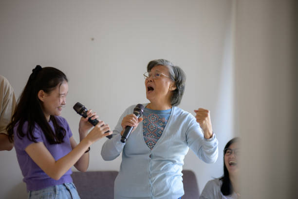 istock Family Harmony: Grandmother and Granddaughter's Karaoke Fun 2160373155