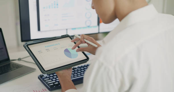 istock Professional Reviewing Financial Planning on Tablet. 2160373527