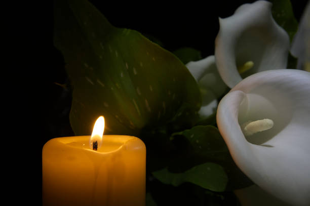 istock Burning wax candle in close up and white calla lily 2160375204