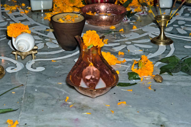 still picture image of floor where holy puja is performed alongwith utensils incense sticks and candles in India