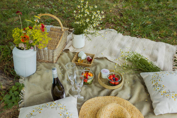 istock Beautiful white boho style decor. Picnic in nature on the grass under the tree 2160376138