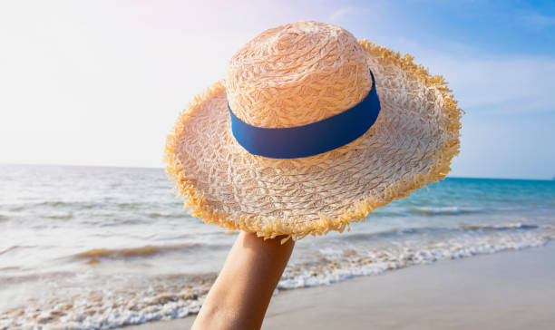 istock Happy holiday in summer with Sun Hat on the beach as blue sky background 2160376292