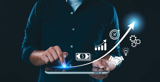 istock A businessman touches a virtual screen displaying a graph of increased sales volume with a shopping cart icon, illustrating the concept of sales growth in e-commerce. 2160378323