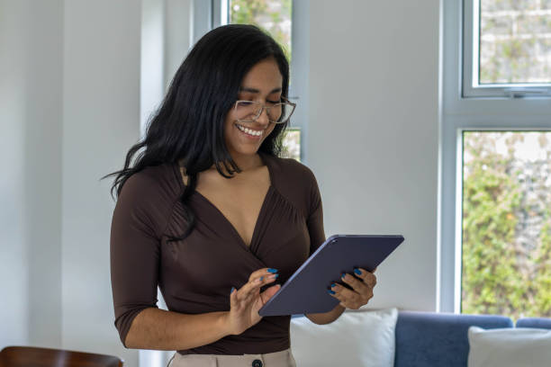 istock Latin American woman working on her tablet. 2160378488