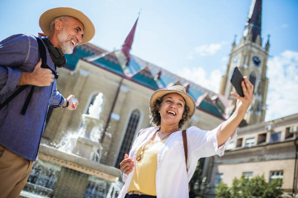 istock Elderly married couple exploring new city. Taking selfie 2160379053