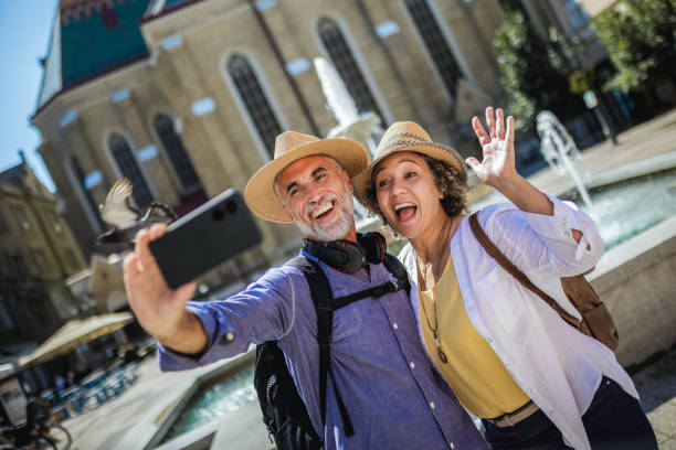 istock Elderly married couple exploring new city. Taking selfie. 2160379296