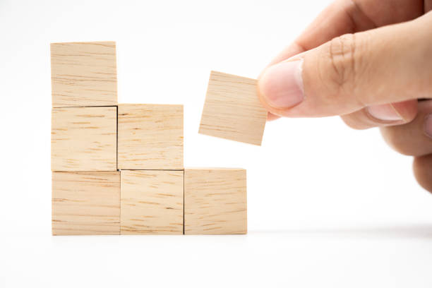 istock Hand putting and stacking blank wooden cubes on white background  with copy space for input wording and infographic icon. 2160381006