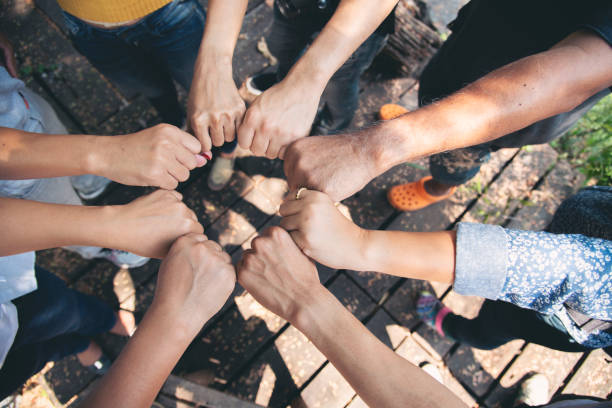 istock Diverse multiethnic Partners hands together teamwork group of multiracial people meeting join hands togetherness. Diversity people hands join empower partnership teams connection volunteer community 2160383747