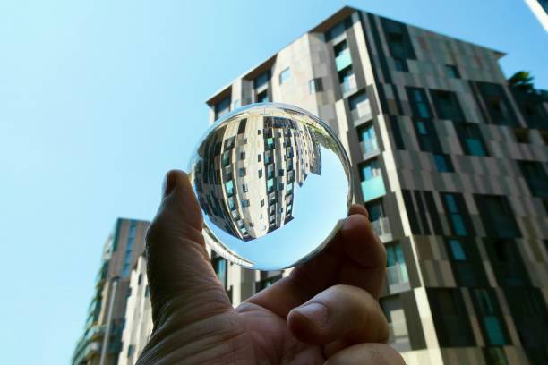 istock Hand holding crystal ball with skyscraper background 2160384476