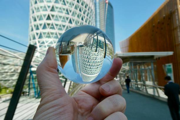 istock Hand holding crystal ball with skyscraper background 2160384489