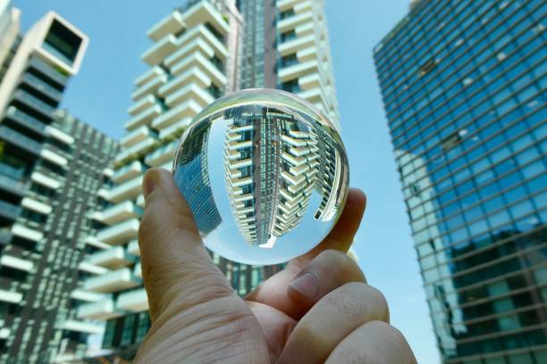istock Hand holding crystal ball with skyscraper background 2160384526