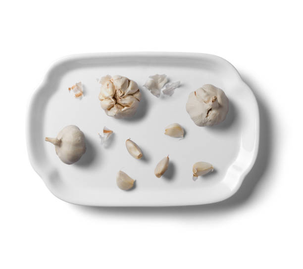 istock Bulb of white garlic on white plate, on white background. 2160385091