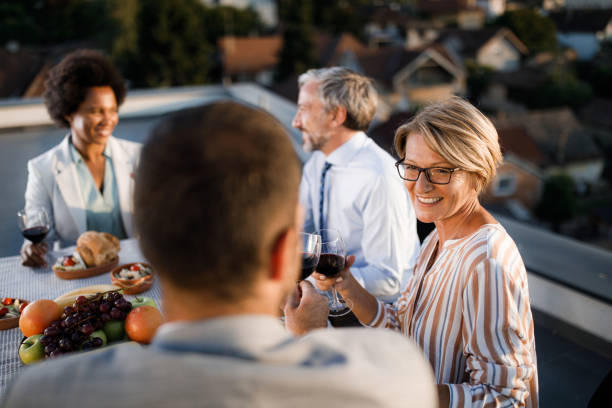 istock Happy business colleagues toasting during lunch on a patio. 2160392330