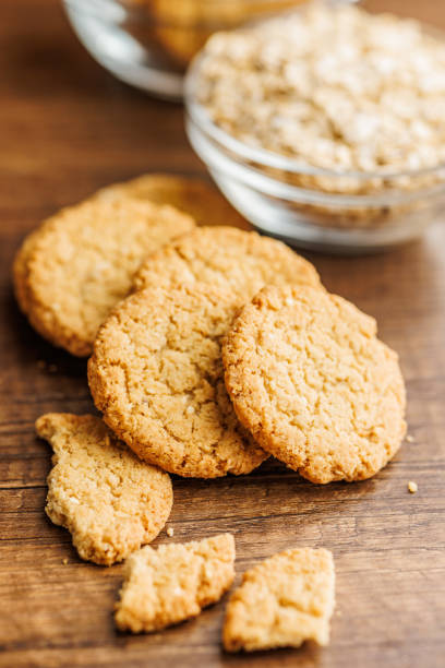 istock Tasty oatmeal cookies and rolled oat on wooden table. 2160394607