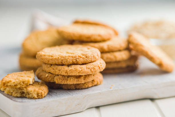 istock Tasty oatmeal cookies on cutting board on white table. 2160394931