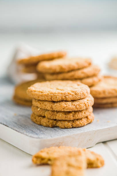 istock Tasty oatmeal cookies on cutting board on white table. 2160394933