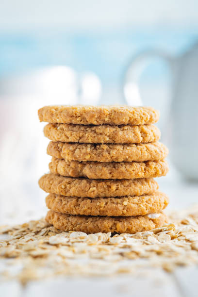 istock Tasty oatmeal cookies and rolled oat on white table. 2160395158