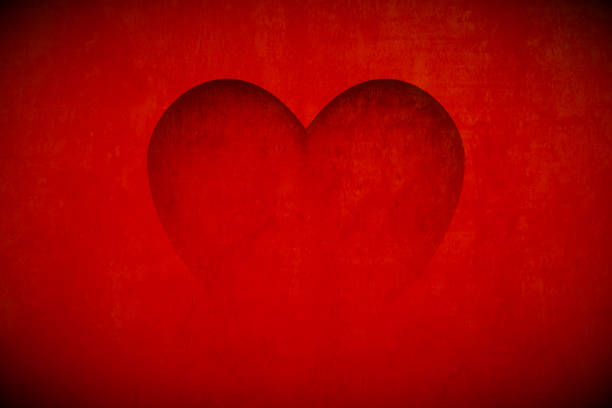 istock Love theme Valentine's Day Red maroon horizontal background - One big shaded heart over vibrant maroon coloured backdrop with glow and vignette 2160396265