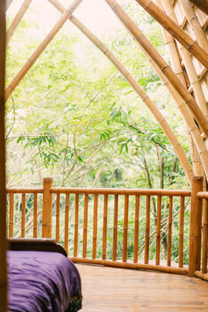 istock Close-up of Bamboo Villa Bed ad Balcoy Overlooking Greenery 2160396583