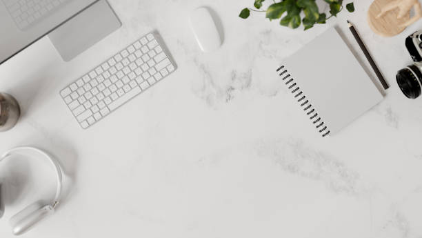 istock A white marble office desk top view features a computer, headphones, stationery, and a copy space. 2160397827