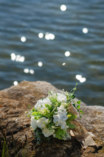 istock Wedding bridal bouquet on the riverbank 2160401048