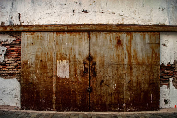 istock an old rusty iron warehouse door or gate on a fragile old brick wall 2160401286