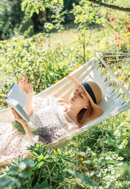 istock Young woman relaxing in a hammock outdoors in back yard 2160401432